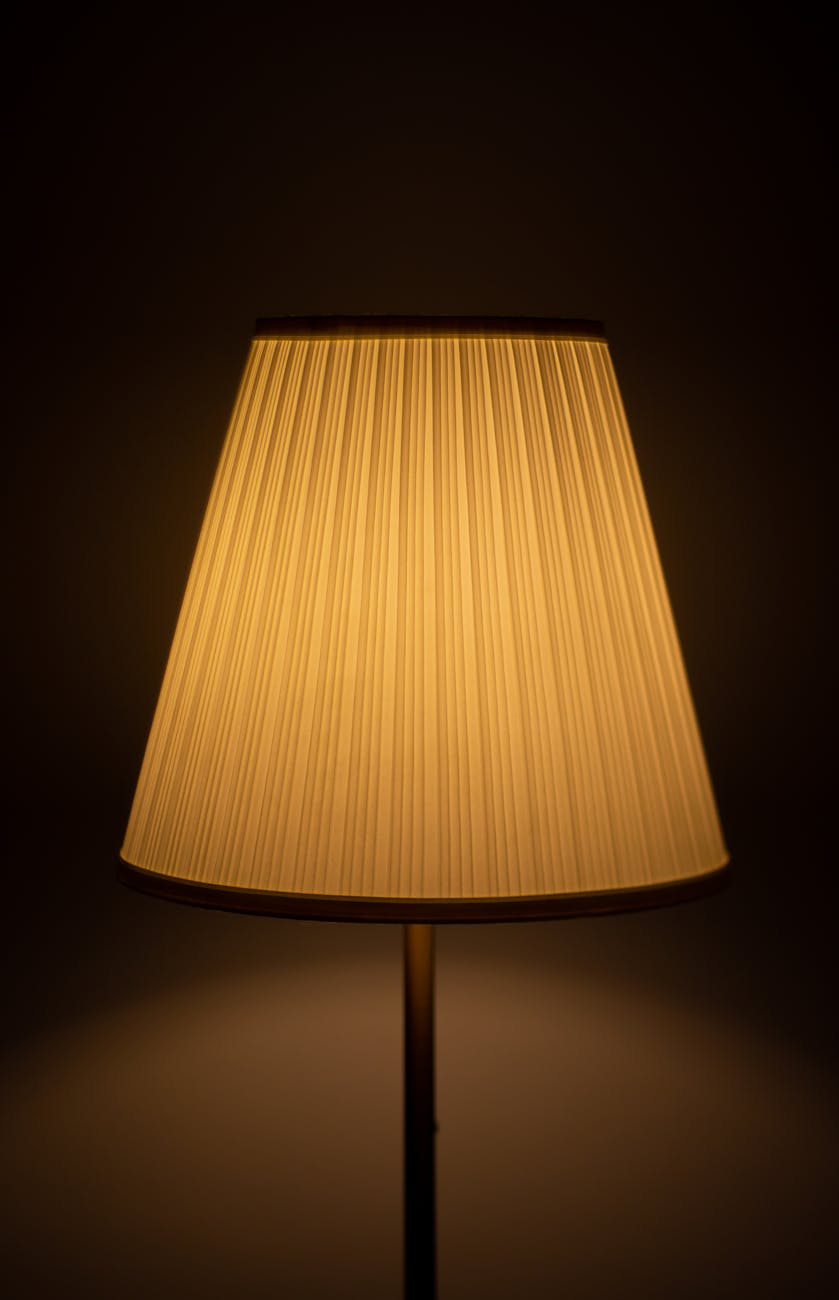 a lamp with a shade on it in a dark room
